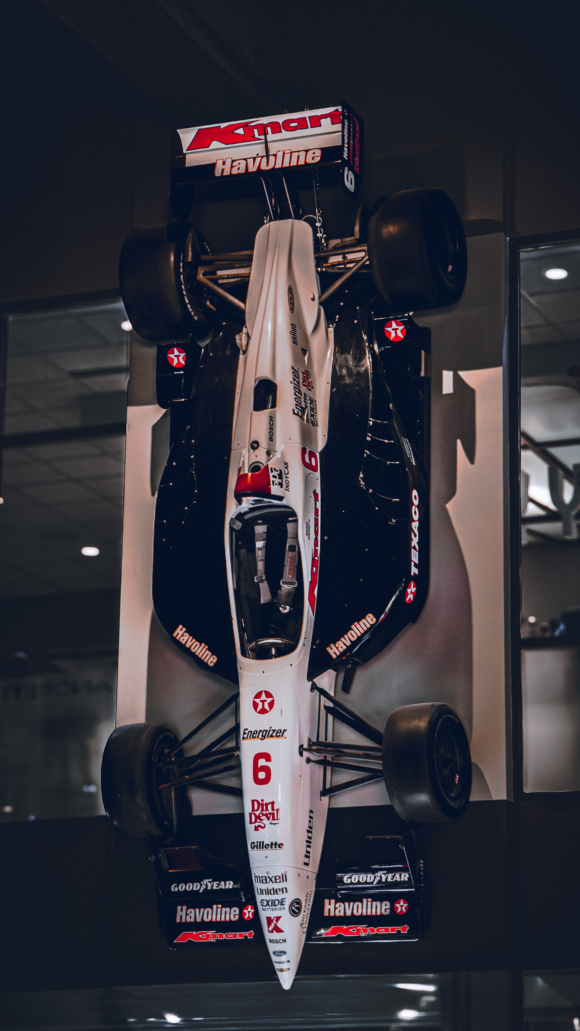 Kmart Havoline IndyCar #6 mounted overhead in a museum display