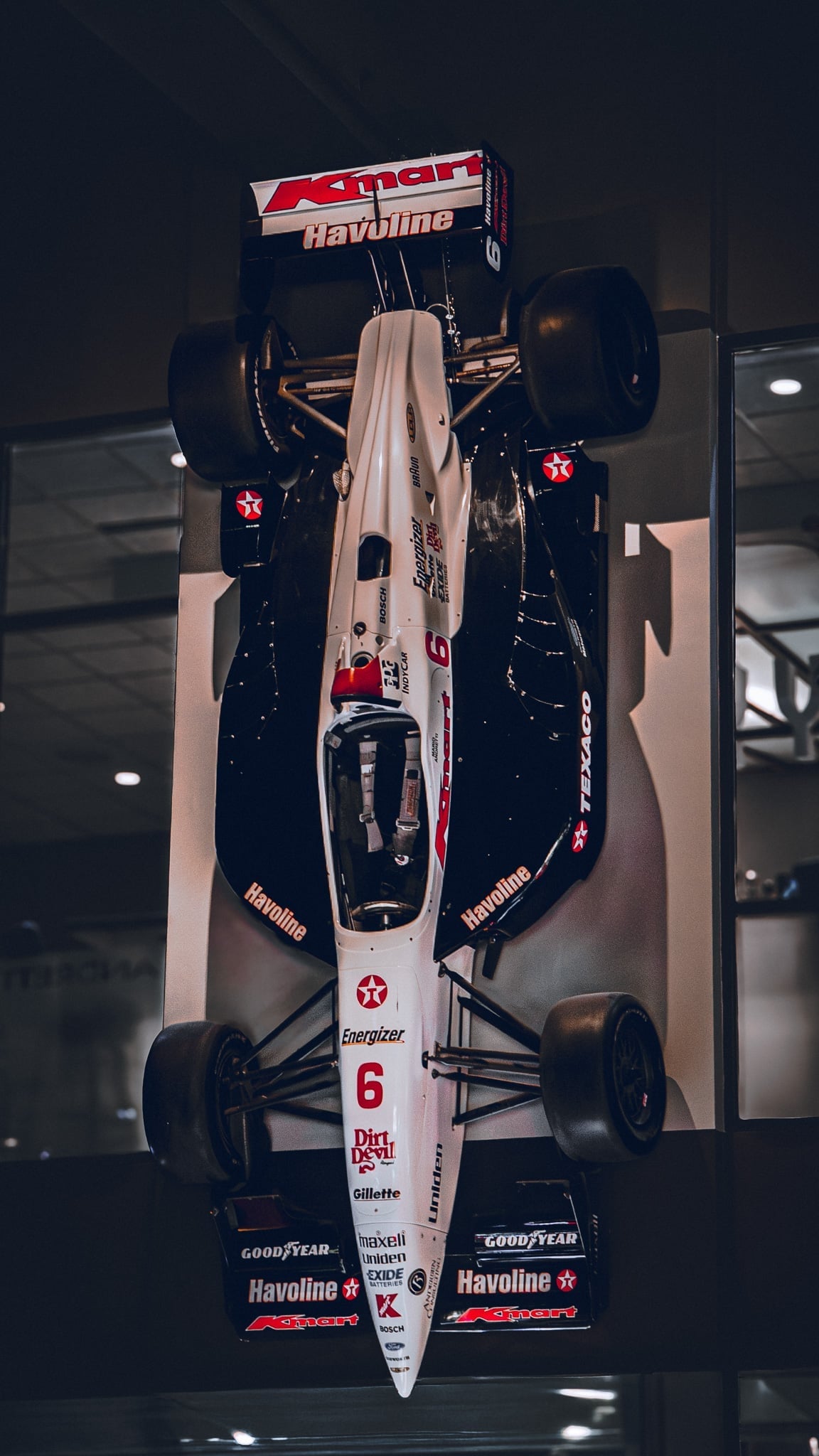 Kmart Havoline IndyCar #6 mounted overhead in a museum display